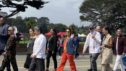 Asm. Addis waving and walking down street with others at Oaxaca by the Sea, a beautiful celebration hosted by the City of Seaside