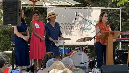 Asm. Addis onstage, speaking at podium at the Community Foundation San Luis Obispo County 25th Anniversary Summer Picnic