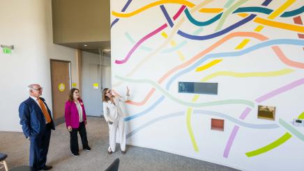 Asm. Addis, Dr. Swick and Ohana administrator on tour, viewing colorful interior wall