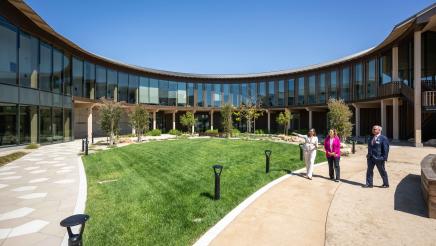 Asm. Addis, Dr. Swick and Ohana administrator on tour, viewing courtyard of building