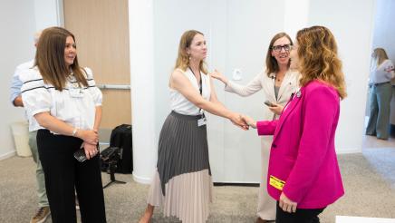 Asm. Addis shaking hands with Ohana staffer