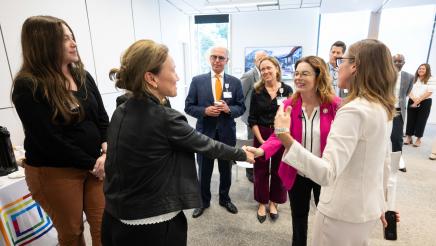 Asm. Addis shaking hands with Ohana staffer