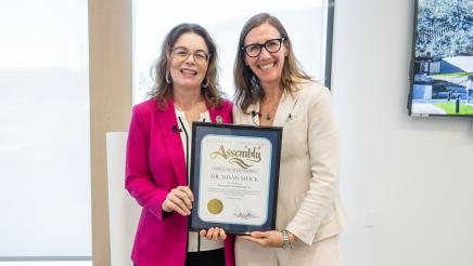 Asm. Addis presenting Dr. Swick with framed certificate