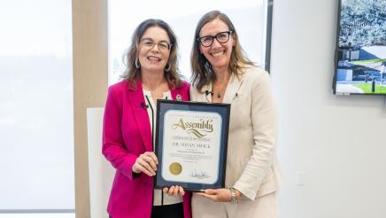 Asm. Addis presenting Dr. Swick with framed certificate