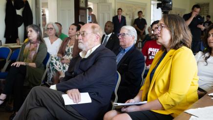 Seated attendees listening on