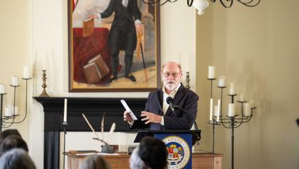 Guest speaker at podium at head of room, speaking