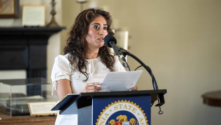 Guest speaker at podium at head of room, speaking