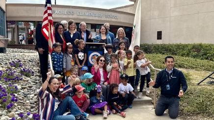 Asm. Addis posing with multiple children and supporters