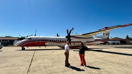 Asm. Addis speaking with man with plane in background